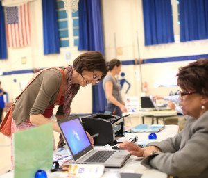 Leslie Shaw checks in at Isaac Dickson Elementary in Asheville to vote in the May 6, 2014, primary election. Colby Rabon/Carolina Public Press