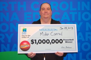 Mike Conrad with his check for $1 million. Photo submitted