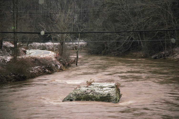 The Watauga River at the bridge on Rominger Road. Normally, the entire boulder is visible. Before the flood on Wednesday, five more feet of this boulder was visible. Photo by Jesse Wood