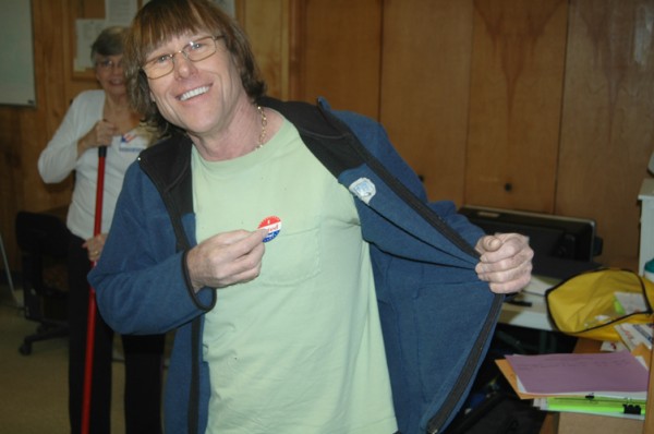 Joe Calhoun puts on his "I Voted" sticker in the Cove Creek Fire Department polling precinct.