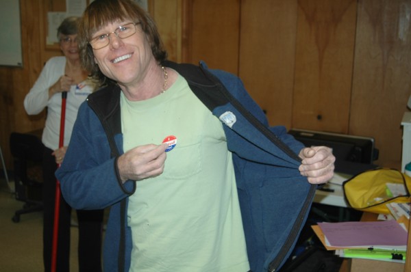 Joe Calhoun puts on his "I Voted" sticker in the Cove Creek Fire Department polling precinct. 