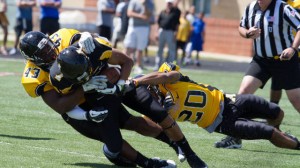 Denzel Ward (43) and Henry Barnes team up on a tackle. Photo by Tyler Buckwell