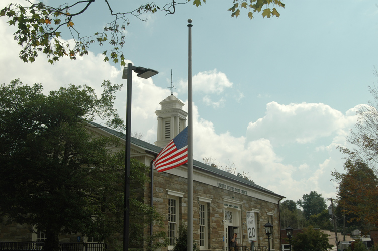 On the 12th anniversary of the 9/11attacks, the American flag flies half-mast at the downtown Boone post office. Photo by Jesse Wood