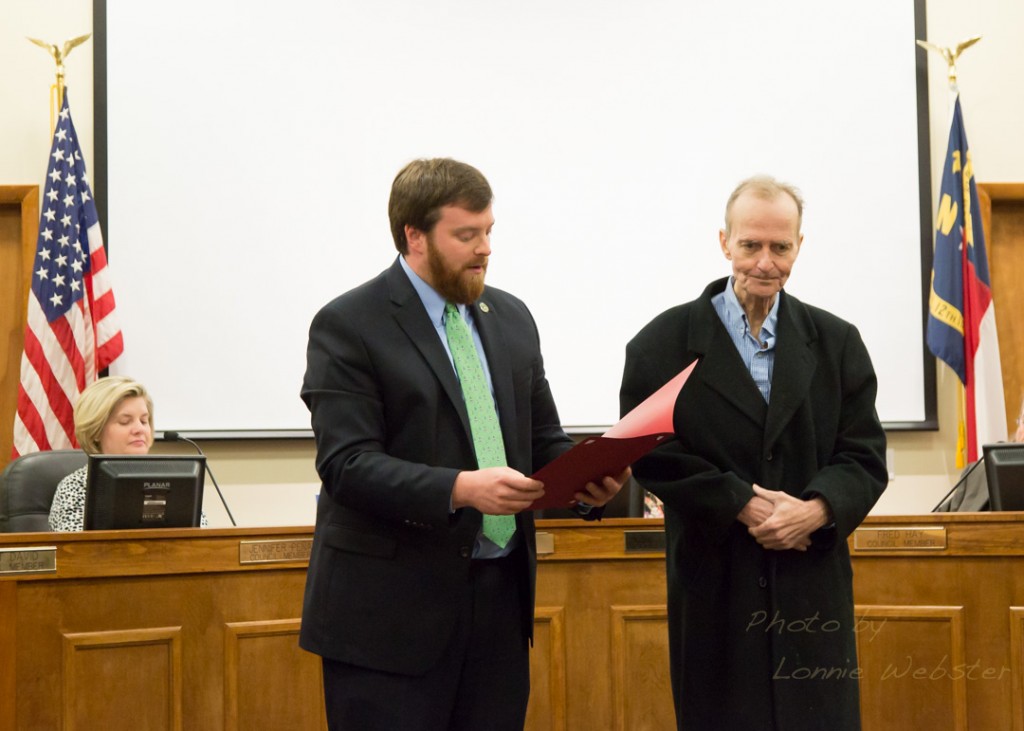 Mayor Andy Ball reads the resolution from the town recognizing Joe Shannon.
