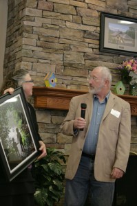 Kathy Parham presents Jim Atkinson with framed photo by Megan Long. Photo by Jennifer Spell