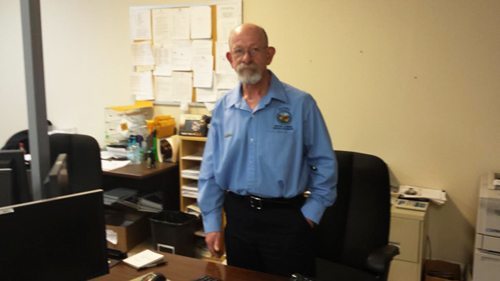 Lyons standing in front of his examiner's desk in the Boone NCDMV office. Photo by Jesse Wood