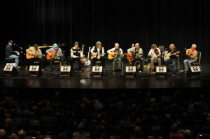 The "My Friend Merle" set at MerleFest 25 featured (left to right) Jeff Little, Richard Watson, Bob Hill, David Holt, T. Michael Coleman, Doc Watson, Mitch Greenhill, Sam Bush, John Cowan and Joe Smother.