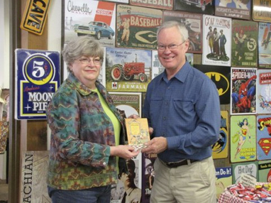 Pam Fisher presents the 1938 program to chair John Cooper.
