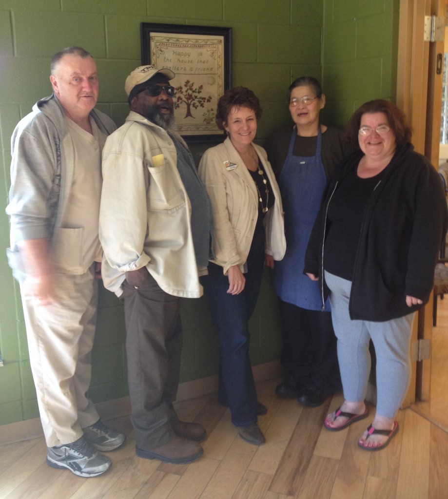 Newly appointed Hospitality House Executive Director Tina Krause, center, with from left, kitchen intern Ronnie Moody Sr., scattered-site housing resident John Gentry, kitchen intern Celeste Law and supportive housing resident Venus Shimko. 