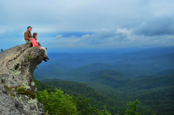 A couple sits on The Blowing Rock. Photo by Todd Bush