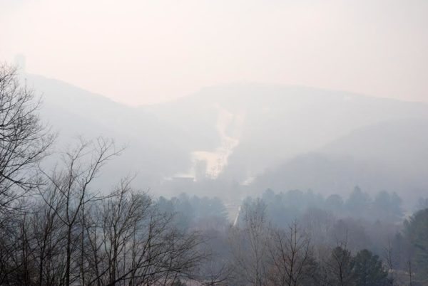 The snow-covered slopes of Sugar Mountain are barely visible in this photo taken today on Wednesday. Photo by Ken Ketchie