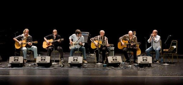 Richard Watson plays the blues with Doc, Bob Hill, Mitch Greenhill, T Michael Coleman, Charles Welch and Buddy Green at a previous MerleFest. Photo by Lonnie Webster