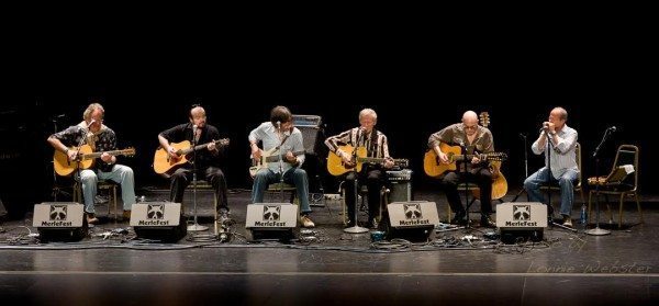 Richard Watson plays the blues with Doc, Bob Hill, Mitch Greenhill, T Michael Coleman, Charles Welch and  Buddy Green at a previous MerleFest. Photo by Lonnie Webster